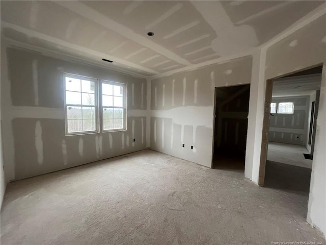 unfurnished room featuring plenty of natural light