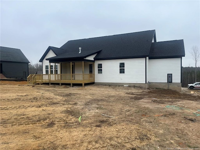 back of property with a wooden deck