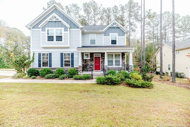 craftsman-style house with a front lawn and covered porch