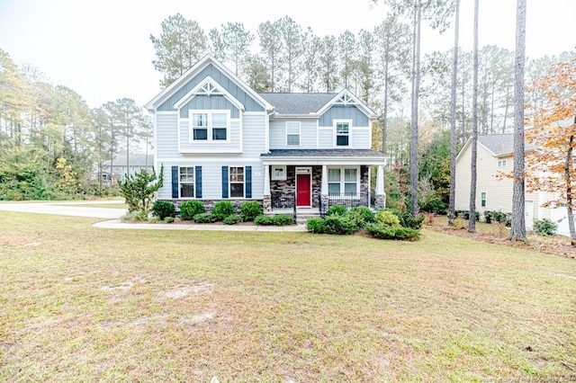 craftsman-style house featuring a front yard and covered porch