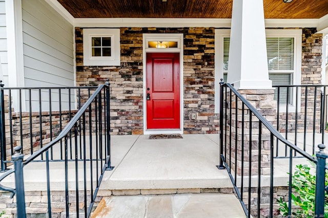 view of exterior entry with covered porch