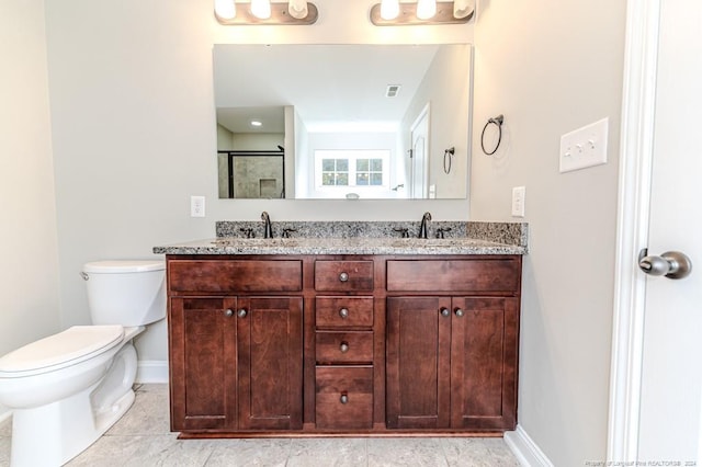 bathroom featuring tile patterned floors, vanity, and toilet