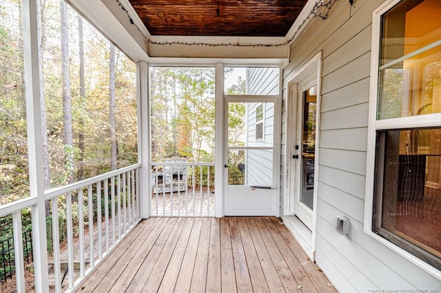 unfurnished sunroom with wooden ceiling