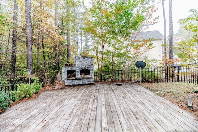 deck featuring an outdoor stone fireplace