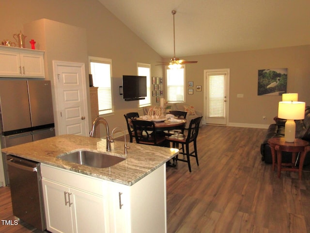 kitchen featuring white cabinetry, sink, dark hardwood / wood-style floors, stainless steel dishwasher, and an island with sink