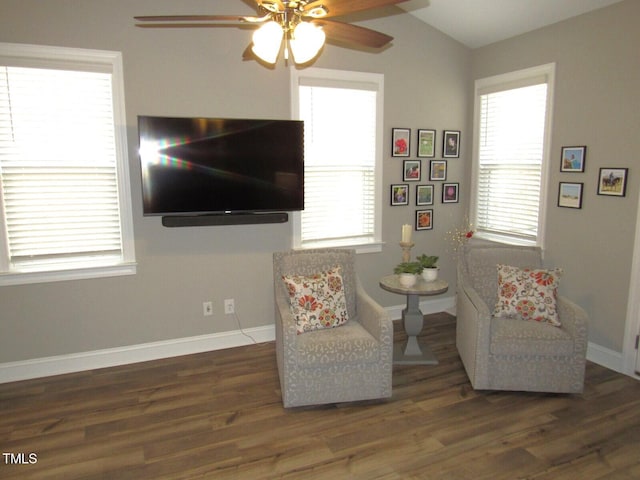 living area featuring dark hardwood / wood-style flooring, lofted ceiling, and ceiling fan