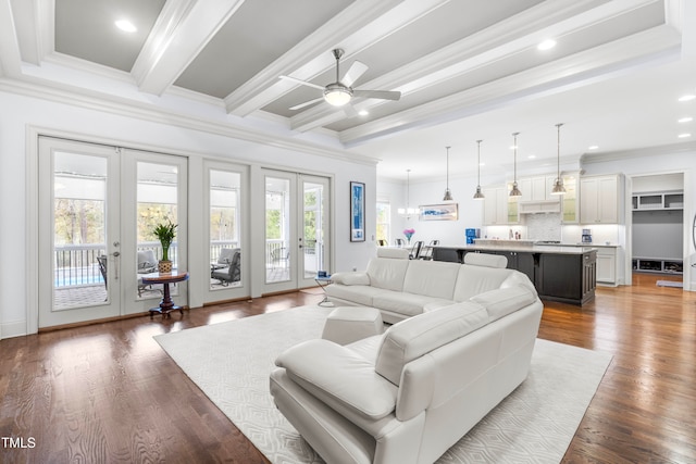 living room with beamed ceiling, ceiling fan, hardwood / wood-style floors, crown molding, and french doors