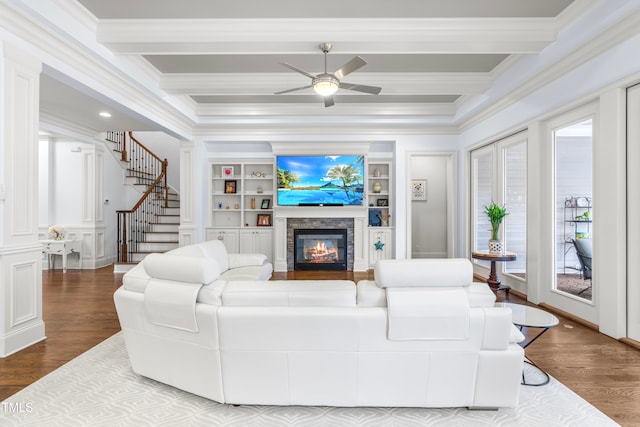 living room with beamed ceiling, wood-type flooring, and ornamental molding