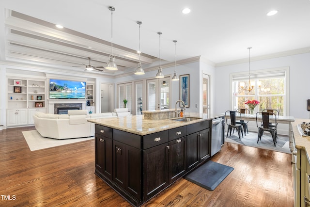 kitchen featuring stainless steel dishwasher, dark wood-type flooring, sink, and pendant lighting