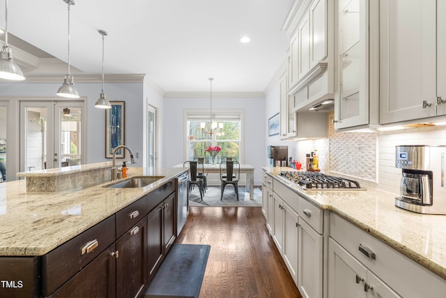 kitchen with stainless steel appliances, white cabinetry, sink, dark brown cabinets, and dark hardwood / wood-style flooring