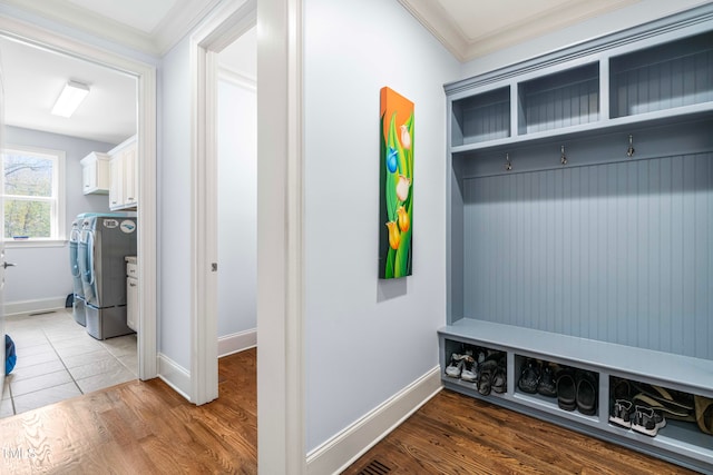 mudroom with washing machine and dryer, crown molding, and dark hardwood / wood-style flooring