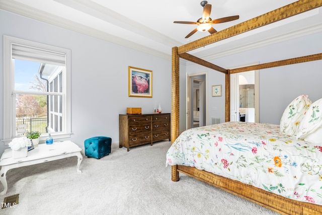 carpeted bedroom featuring ensuite bathroom, ornamental molding, and ceiling fan