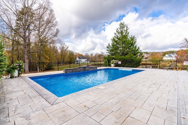 view of swimming pool with a patio and pool water feature