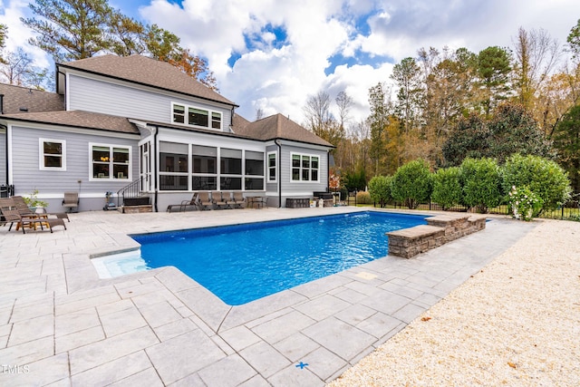 view of pool featuring a patio and a sunroom