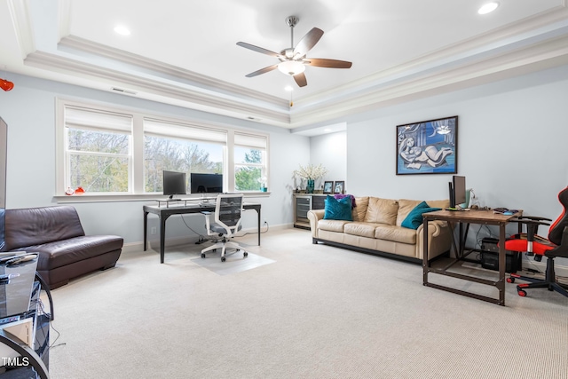 home office featuring a wealth of natural light, light carpet, crown molding, and a tray ceiling