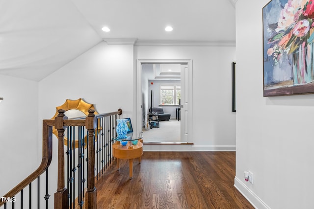 corridor with dark wood-type flooring, crown molding, and lofted ceiling