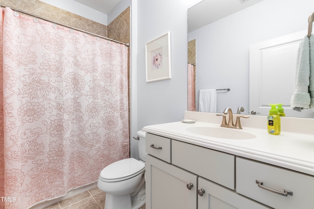 bathroom featuring vanity, tile patterned floors, and toilet