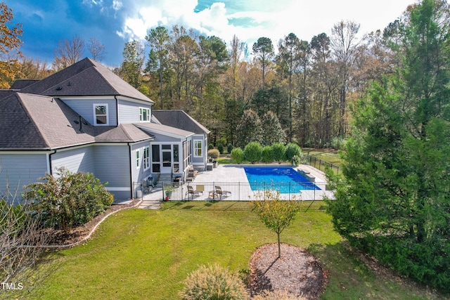 view of swimming pool with a yard and a patio