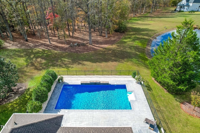 view of pool featuring a lawn and a patio