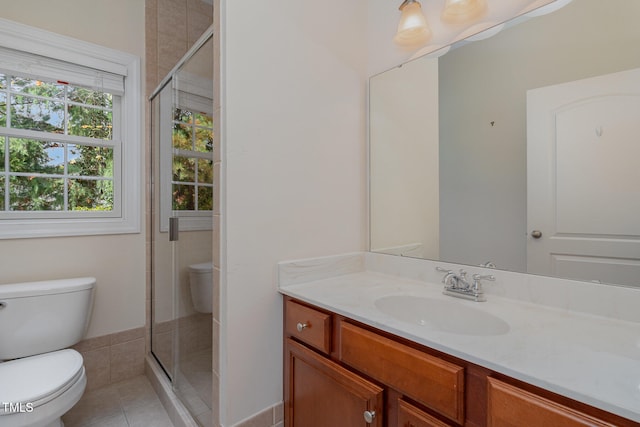 bathroom with toilet, vanity, tile patterned floors, and a shower with shower door