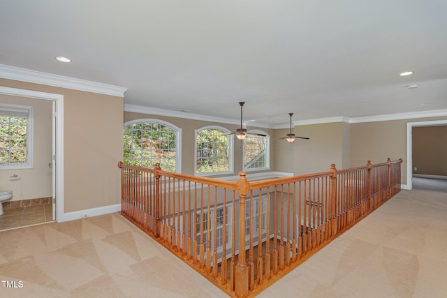 corridor with light carpet and crown molding