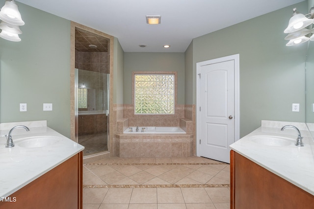 bathroom featuring shower with separate bathtub, vanity, and tile patterned floors