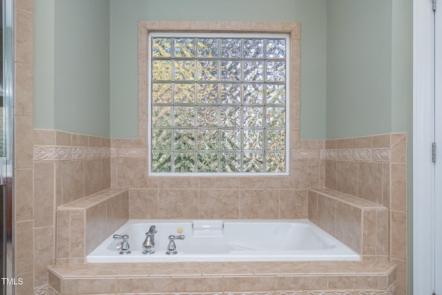 bathroom with a relaxing tiled tub