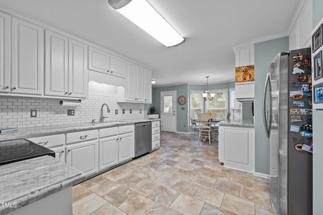 kitchen with sink, white cabinetry, hanging light fixtures, and appliances with stainless steel finishes