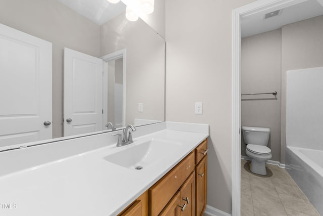 bathroom featuring tile patterned flooring, vanity, and toilet