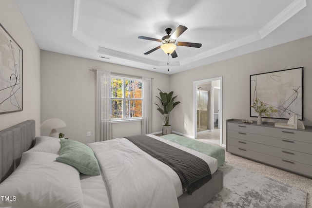 bedroom featuring ensuite bathroom, crown molding, ceiling fan, a raised ceiling, and light carpet