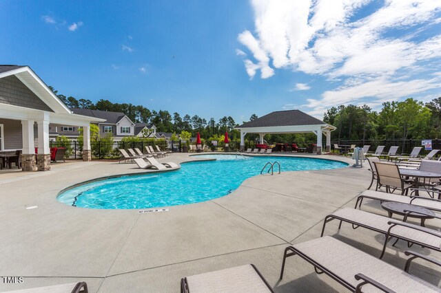 view of pool featuring a gazebo and a patio area