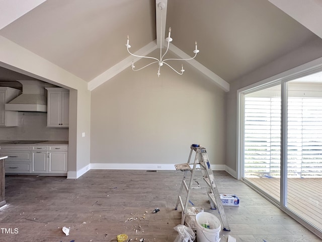 interior space with a notable chandelier, vaulted ceiling with beams, and hardwood / wood-style flooring