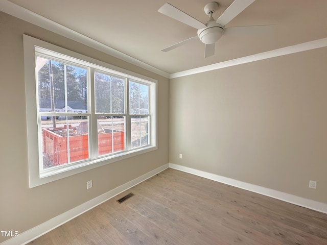 spare room with ceiling fan, hardwood / wood-style floors, and crown molding