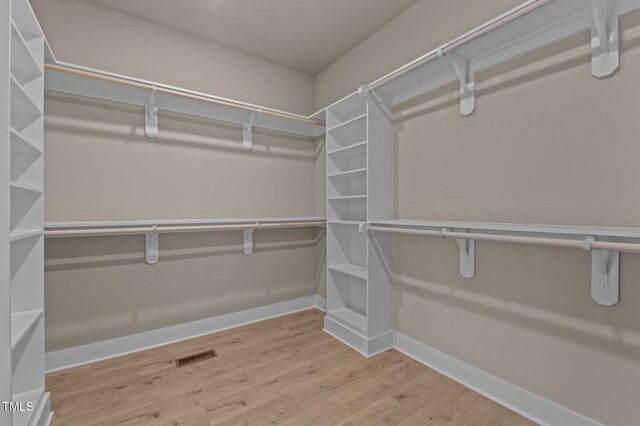 spacious closet with visible vents and wood finished floors