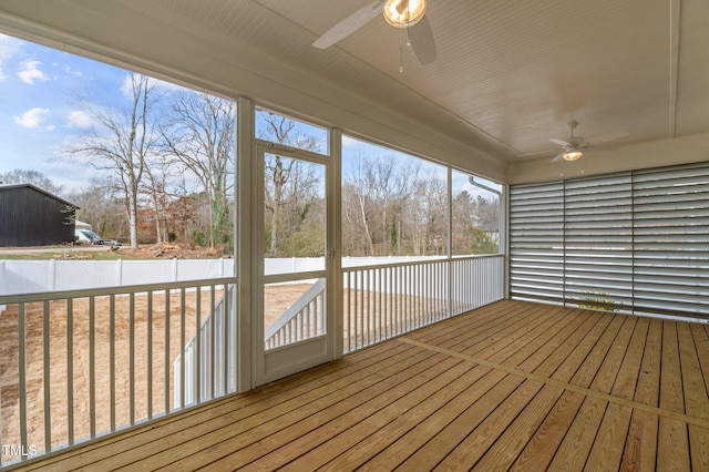 unfurnished sunroom with a ceiling fan and a wealth of natural light