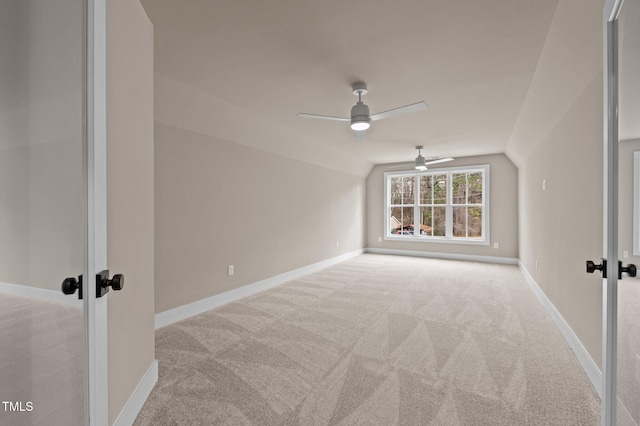 bonus room featuring lofted ceiling, carpet flooring, and baseboards