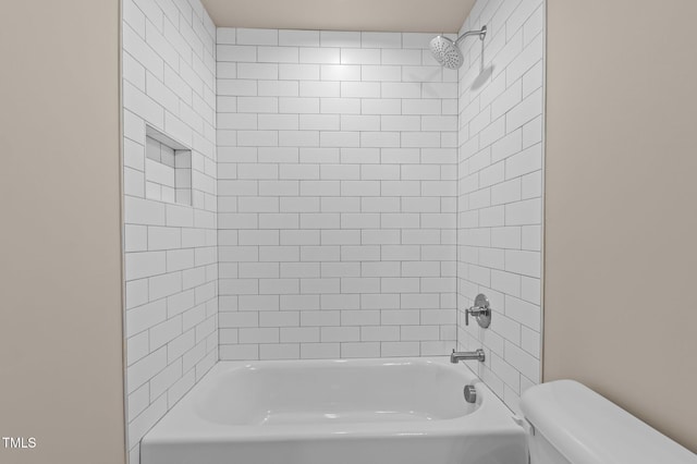 bathroom with bathtub / shower combination and toilet