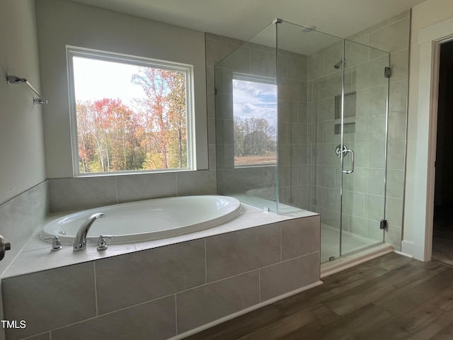 bathroom featuring hardwood / wood-style floors and independent shower and bath