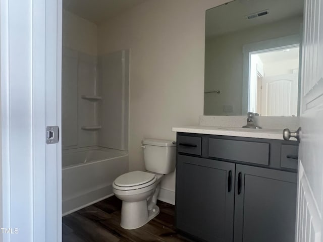 full bathroom featuring toilet, tub / shower combination, vanity, and hardwood / wood-style flooring