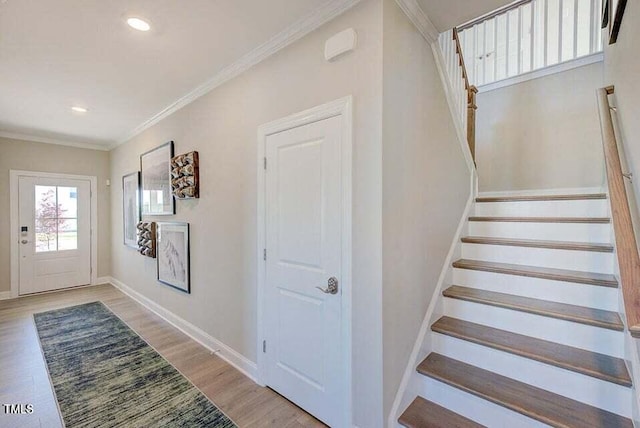 entrance foyer featuring light wood-type flooring and crown molding