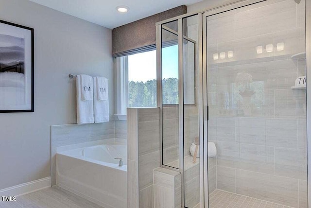 bathroom with shower with separate bathtub