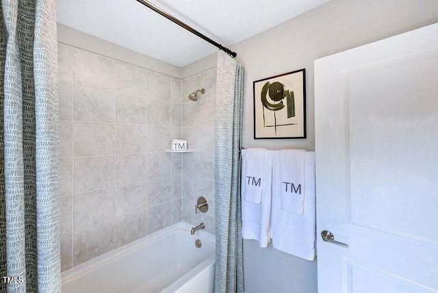 bathroom with shower / bath combo with shower curtain