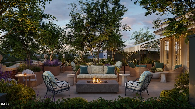 patio terrace at dusk featuring an outdoor living space with a fire pit