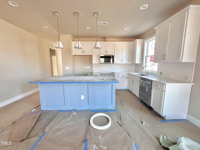 kitchen featuring a kitchen island, white cabinetry, stainless steel appliances, and hanging light fixtures