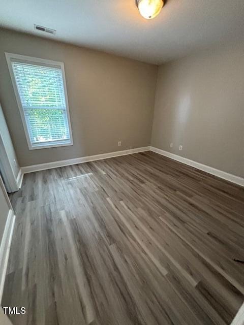 unfurnished room featuring dark hardwood / wood-style floors