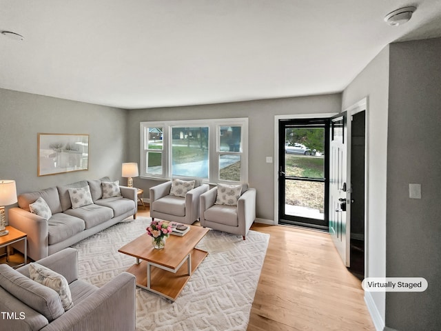 living area with baseboards and light wood-style floors