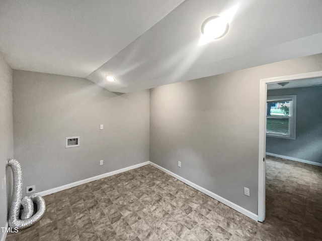 below grade area featuring baseboards and tile patterned floors