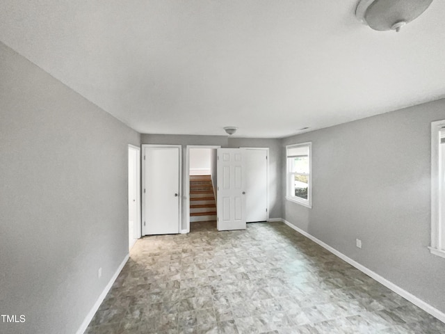 unfurnished bedroom featuring baseboards