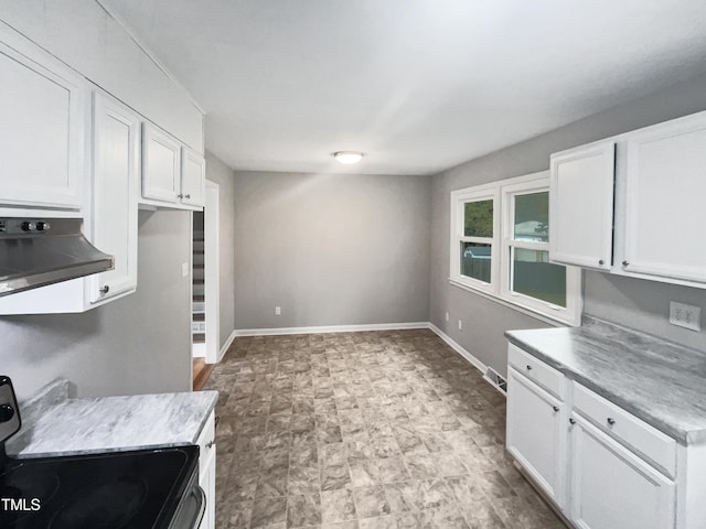 kitchen featuring ventilation hood, white cabinetry, and electric stove