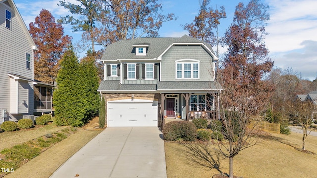 view of front of home featuring a porch and a garage